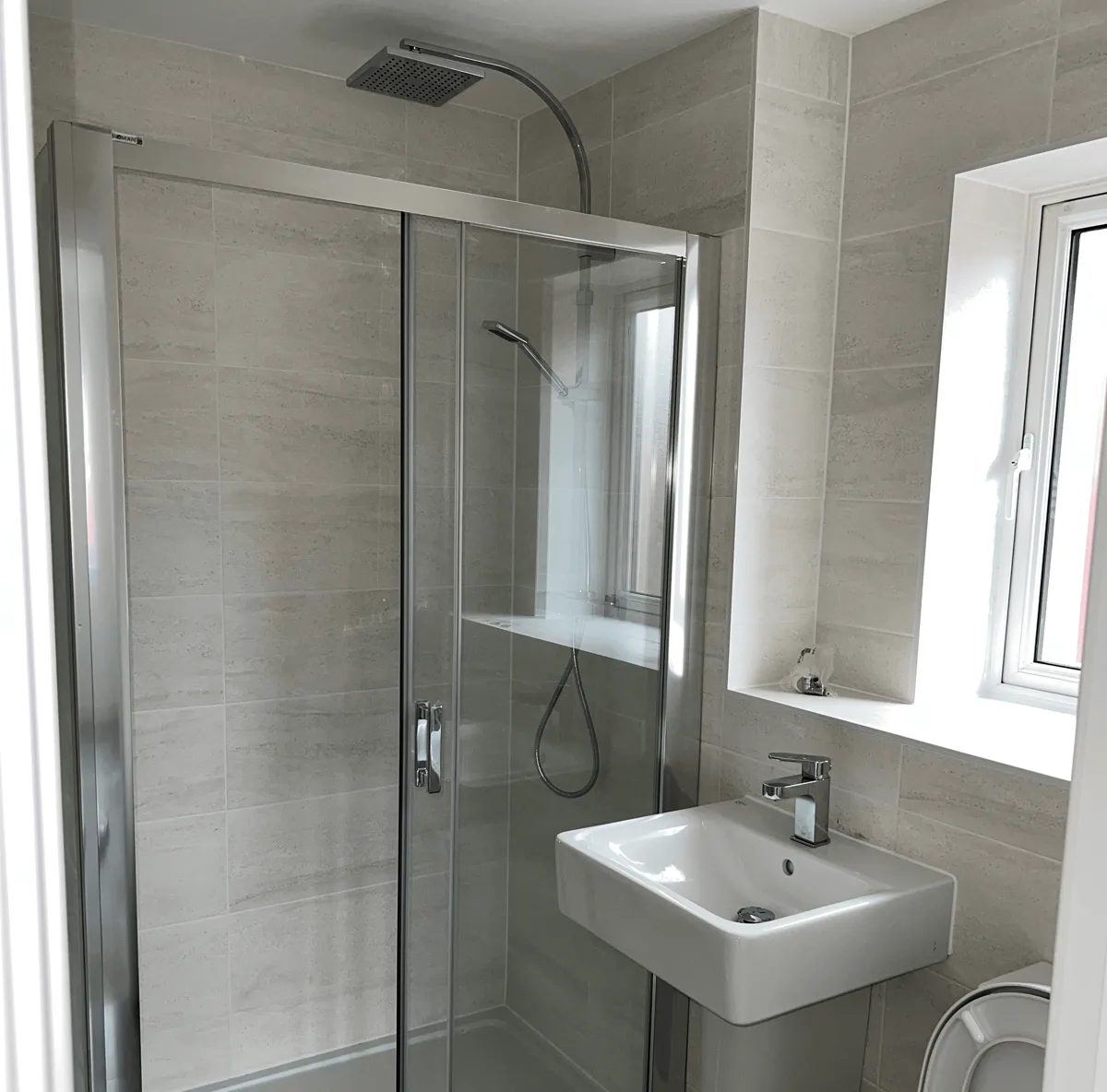 Fully renovated shower room with sliding glass door and new basin