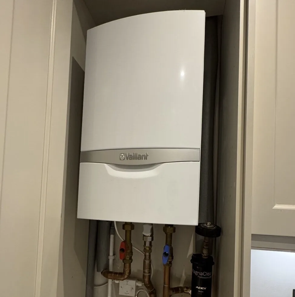 Vaillant combi boiler neatly installed in a cupboard